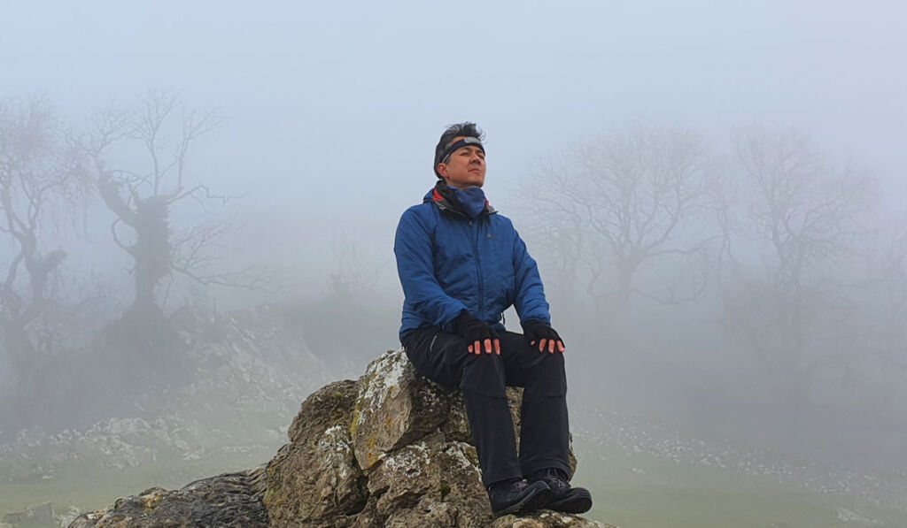 Paul Godbold using the MUSE headband to meditate out in the English countryside