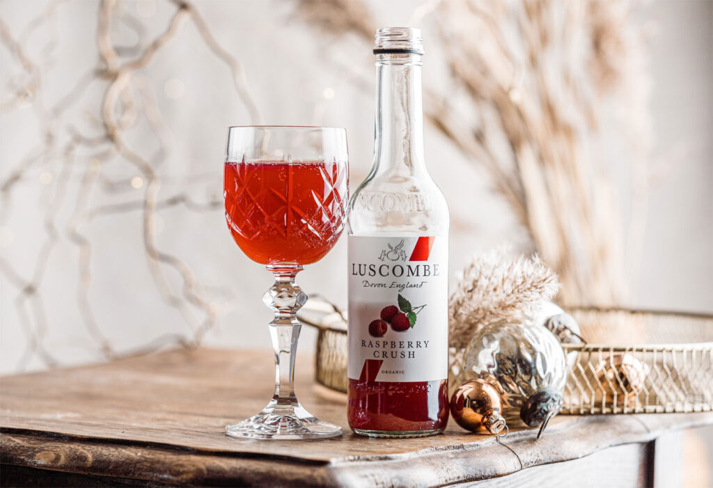 A bottle and glass of Luscombe organic Raspberry Crush