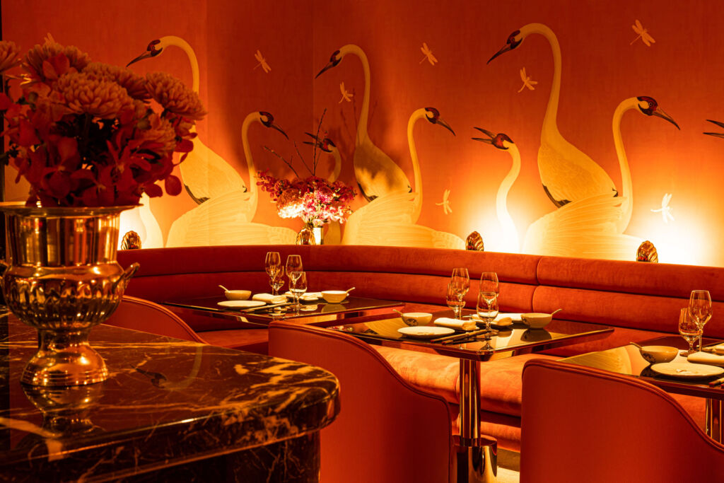 A view inside the restaurant showing the Gucci Heron print wallpaper