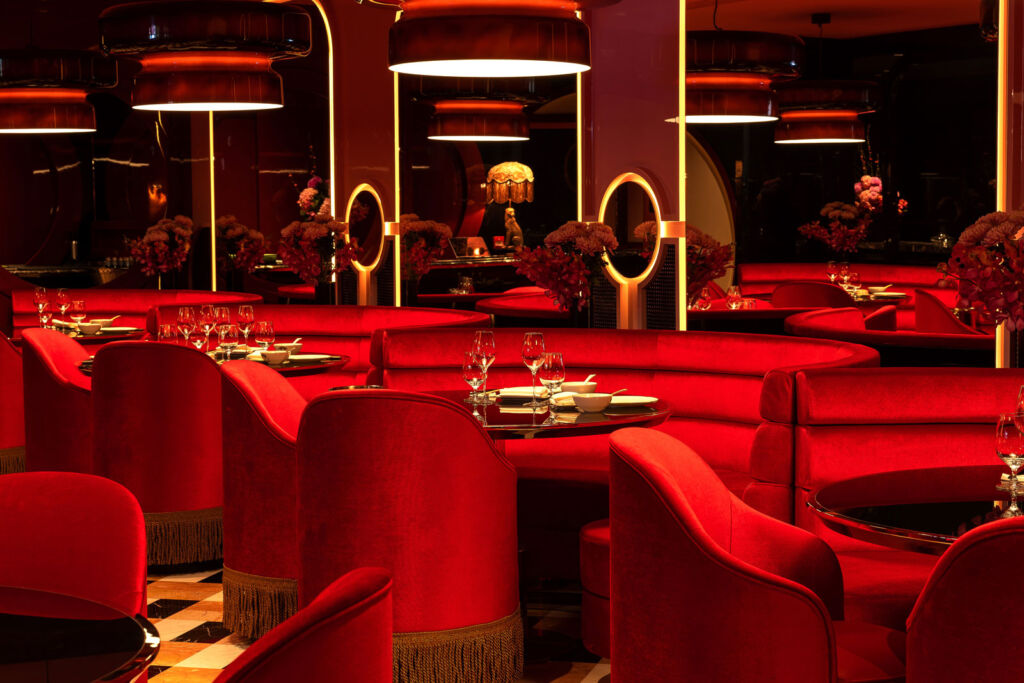 The plush red seating inside the restaurant accentuated by gold elements