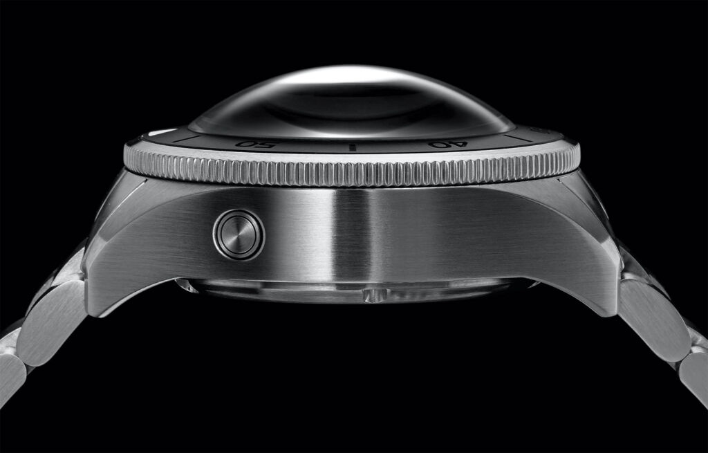 A side profile view of the watch showing its pronounced domed lens