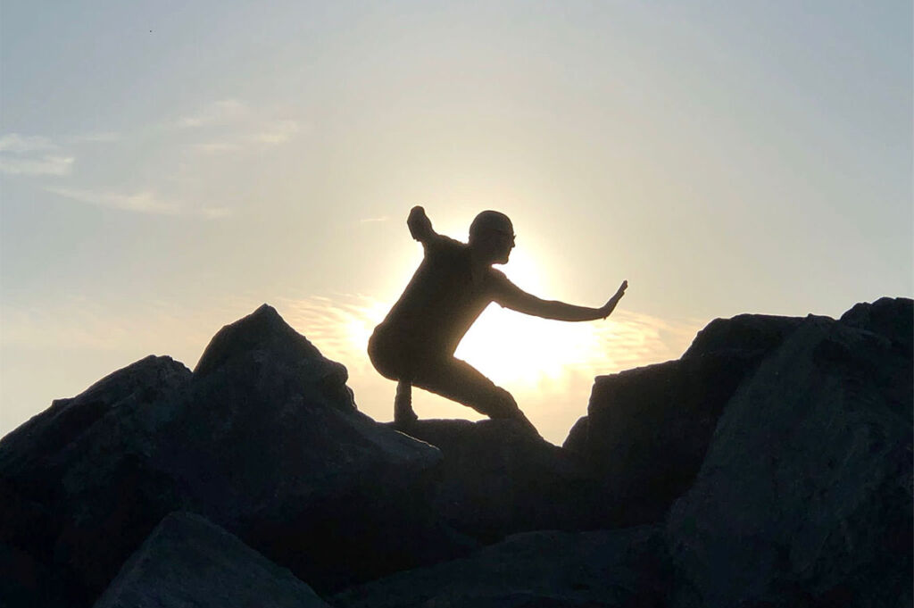 Tim Johnson doing Tai Chi on some rocks at Sunrise