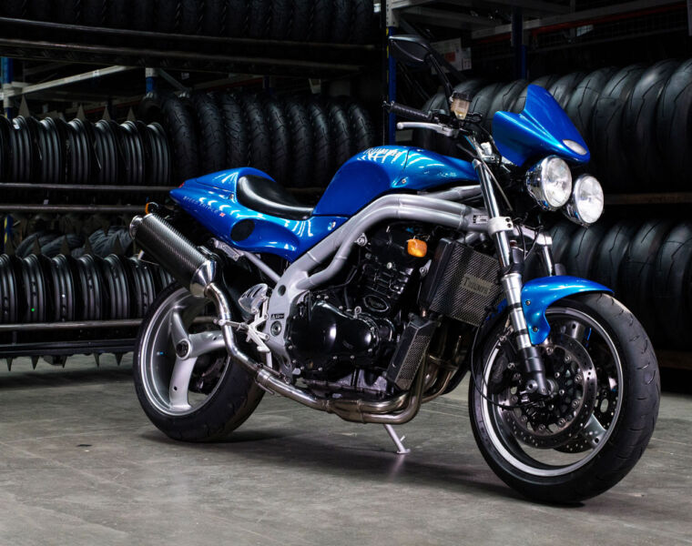 A blue and grey Triumph Speed Triple 1200 RS ready to be ridden