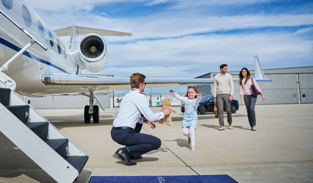 A family boarding a Priester Aviation jet