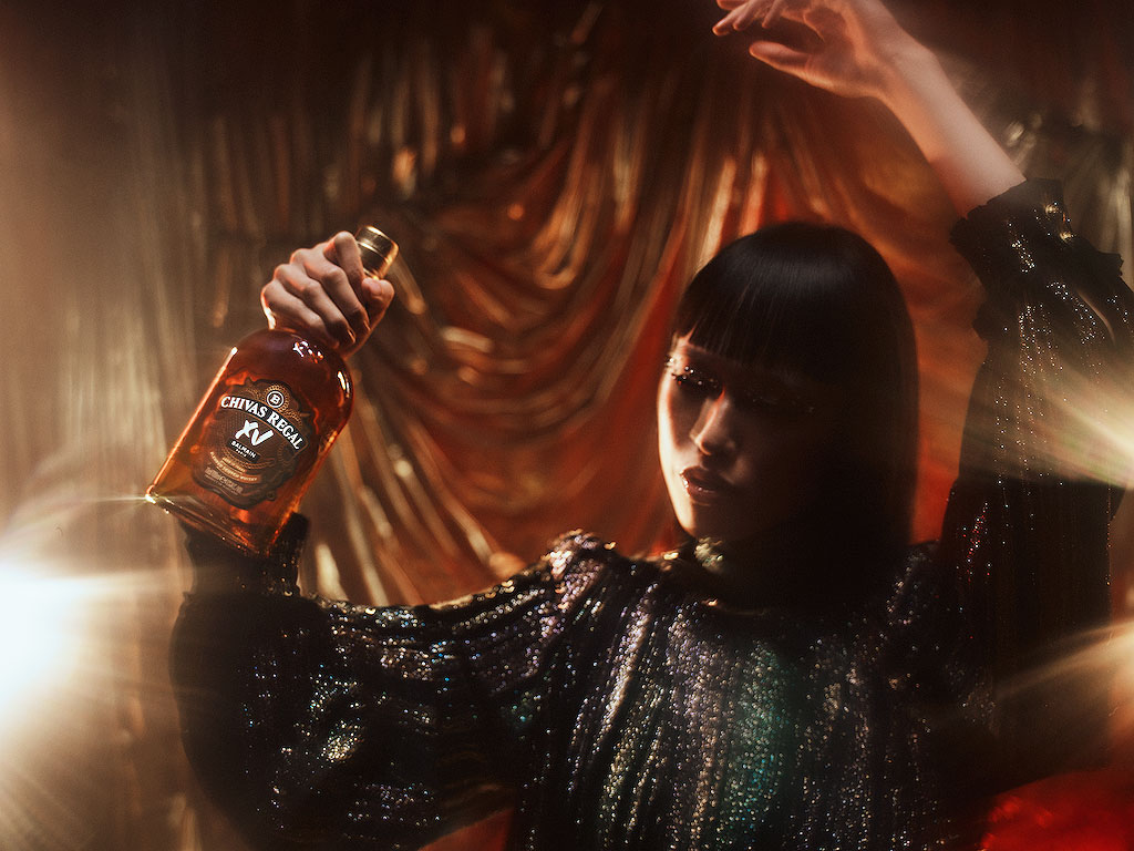 A female model holding one of the limited edition whisky bottles