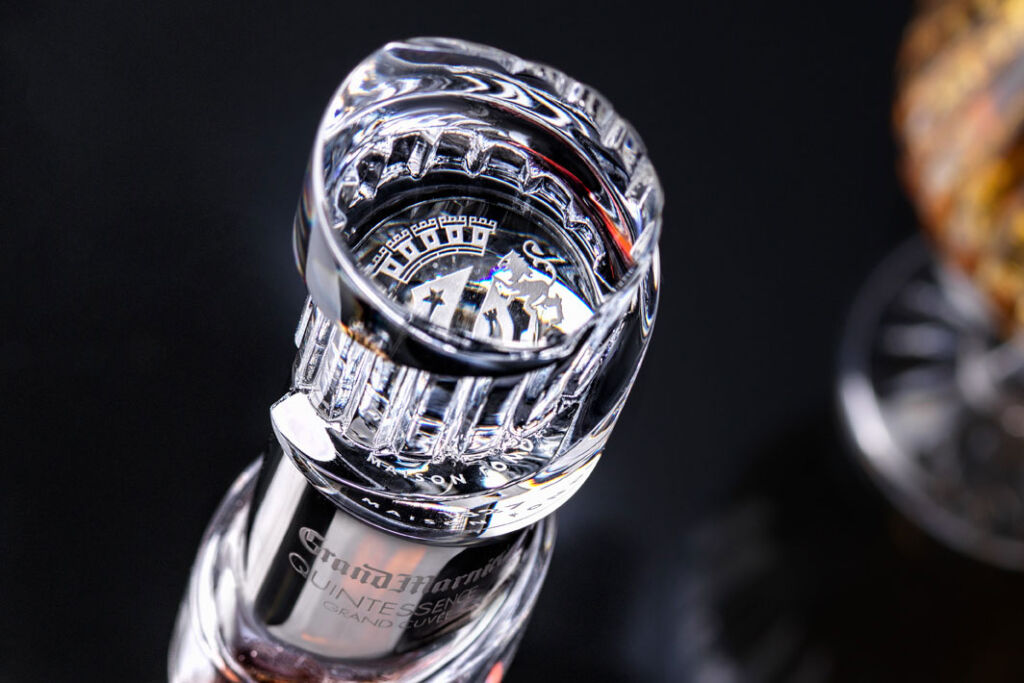 A close up view of the hand blown bottle made by Baccarat showing the engraving on the neck
