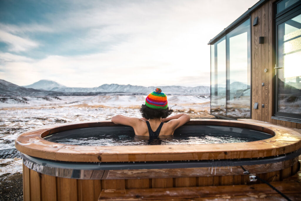 A woman enjoying the views from one of the heated outdoor spa pools
