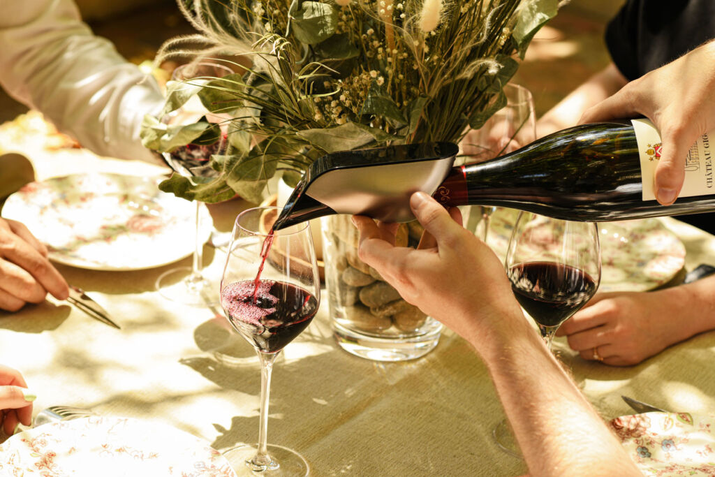 Pouring red wine at a table with the Aveine Wine Aerator