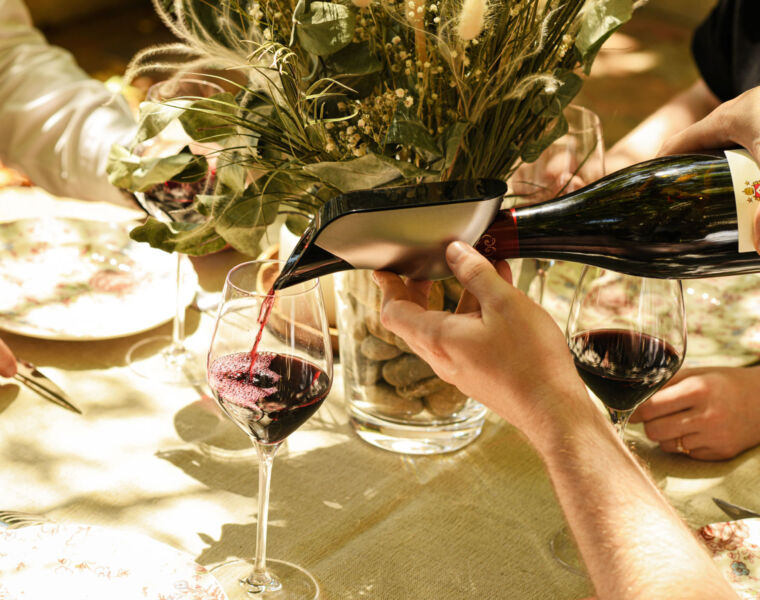 Pouring red wine at a table with the Aveine Wine Aerator