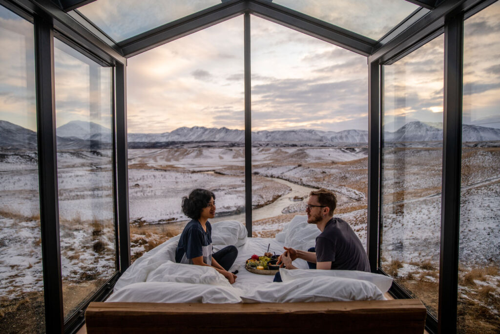 A couple having breakfast in bed surrounded by some incredible views