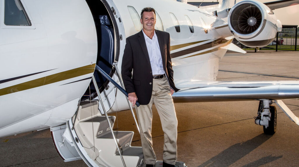 Rich Ropp walking down a private jet's steps
