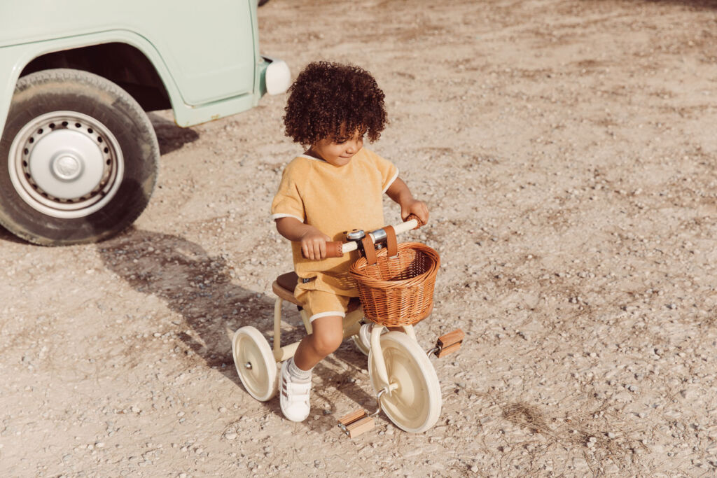 A child riding a Banwood tricycle