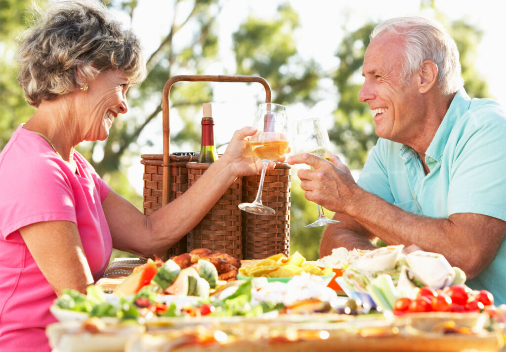 An older couple having a meal outdoors