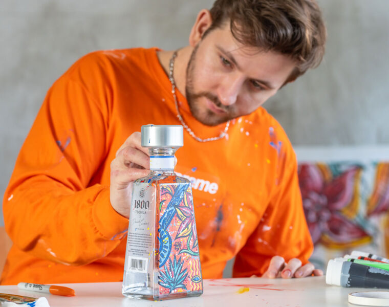 Daniel Cordas hand painting a unique 1800 Tequila bottle