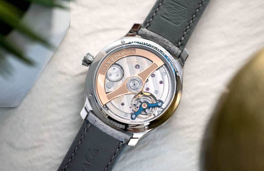 The rear of the timepiece with its glass back showing the movement