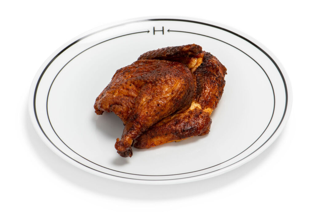 Half a roast chicken on a plate