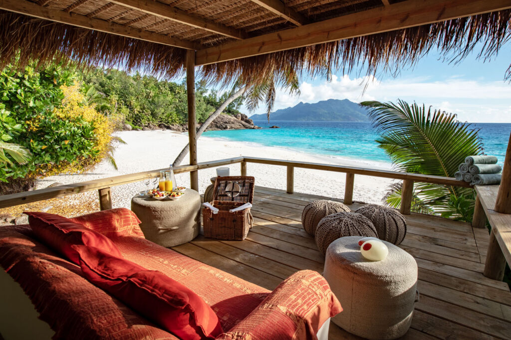 A private cabana on the beach with a wicker food hamper