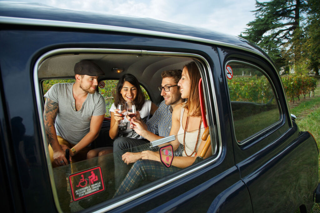 Passengers making a toast in the back of the Wine Cab