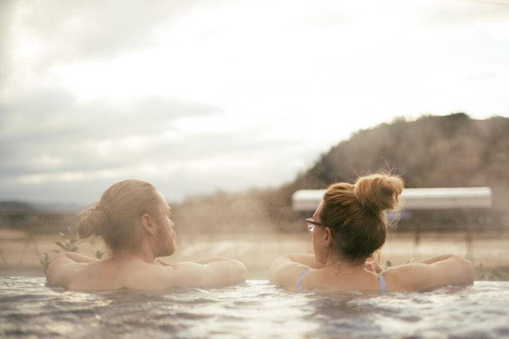 People relaxing in the outdoor hot tub at Adventure Parc Snowdonia