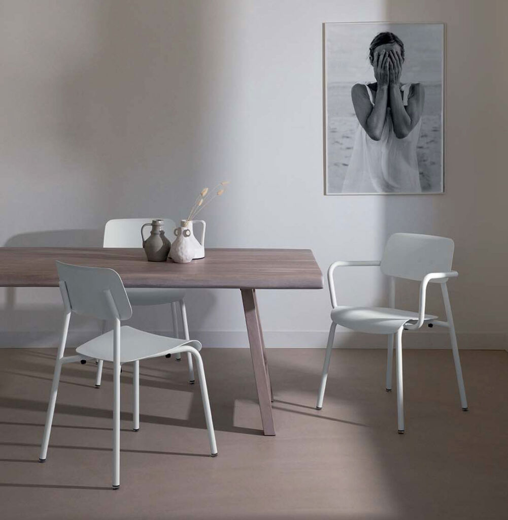 White versions of the minimalist chairs next to a wood dining table in the home