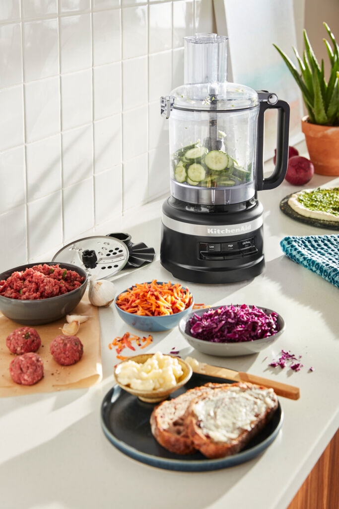 The food processor in the kitchen next to some of its delicious creations