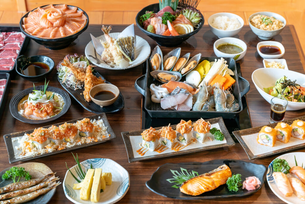 A table filled with Japanese food dishes