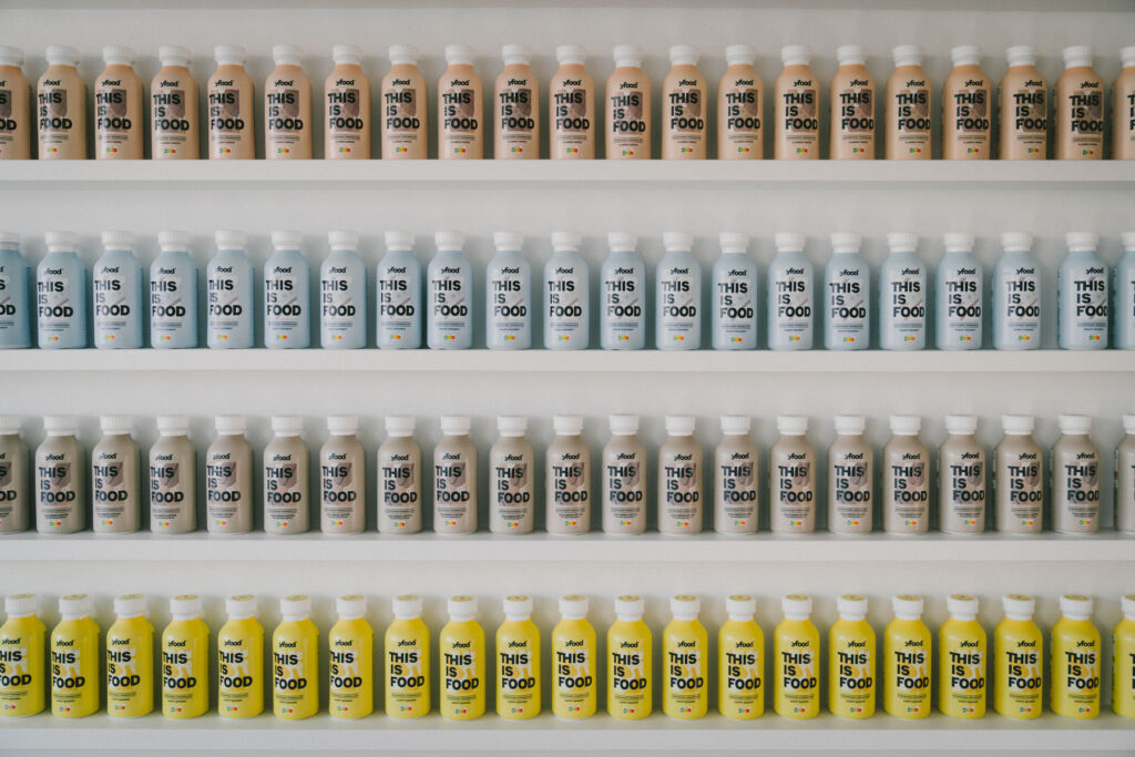 A shelf filled with bottles containing the company's special food formula