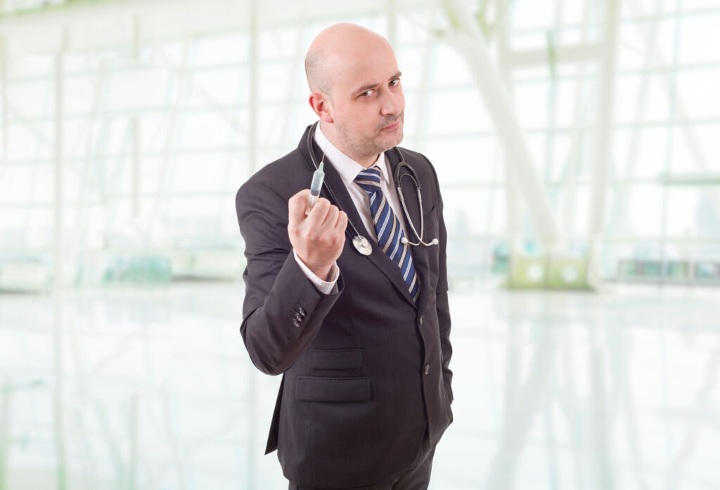 A male doctor holding a syringe in his hands