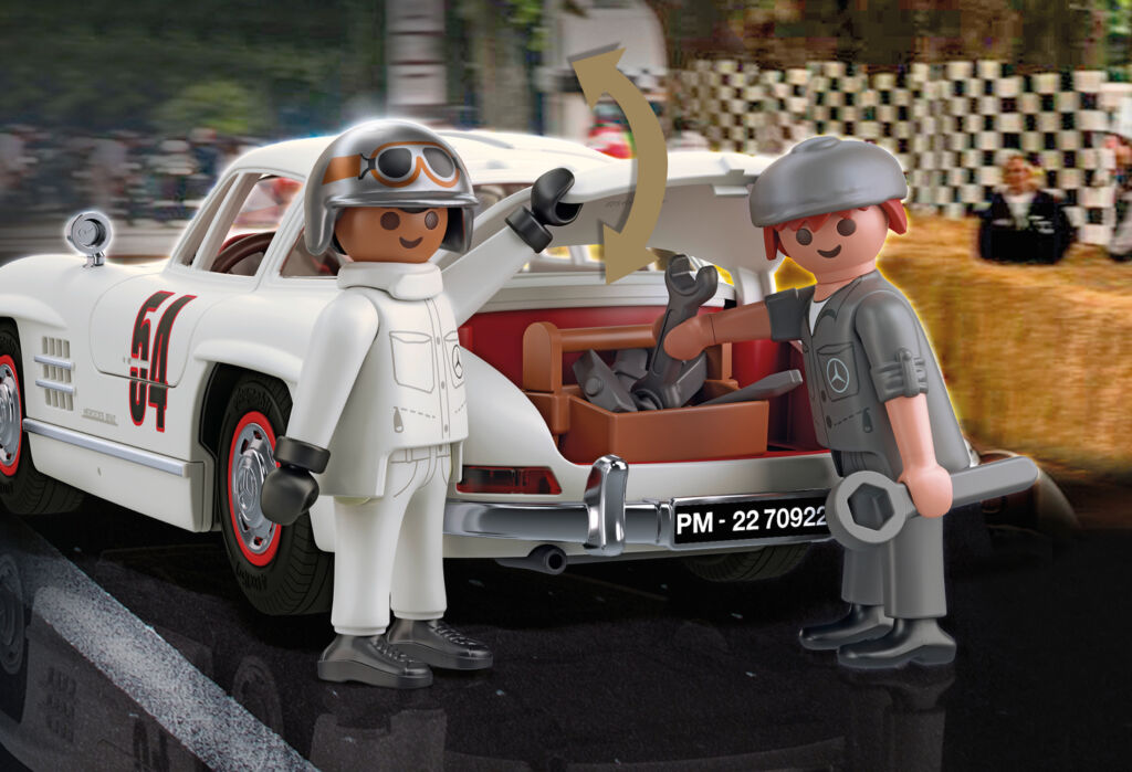 Two Playmoil figures taking items out of the 300 SL's trunk