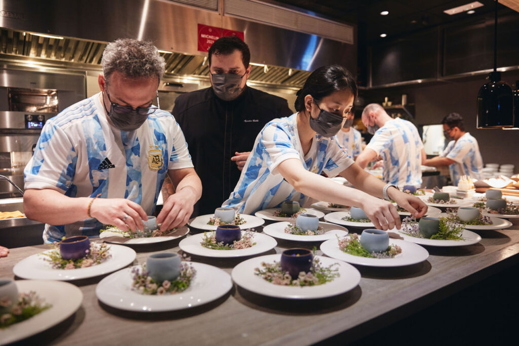 The Ando restaurant team wearing Argentinina football shirts in the restaurant