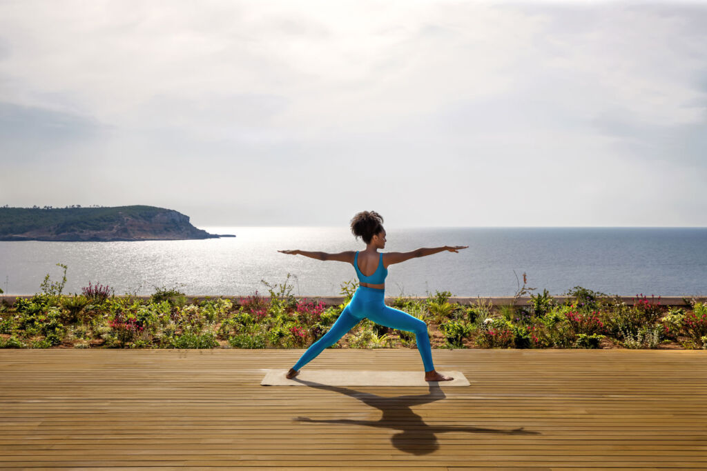 A woman practicing yoga at the Six Senses Ibiza