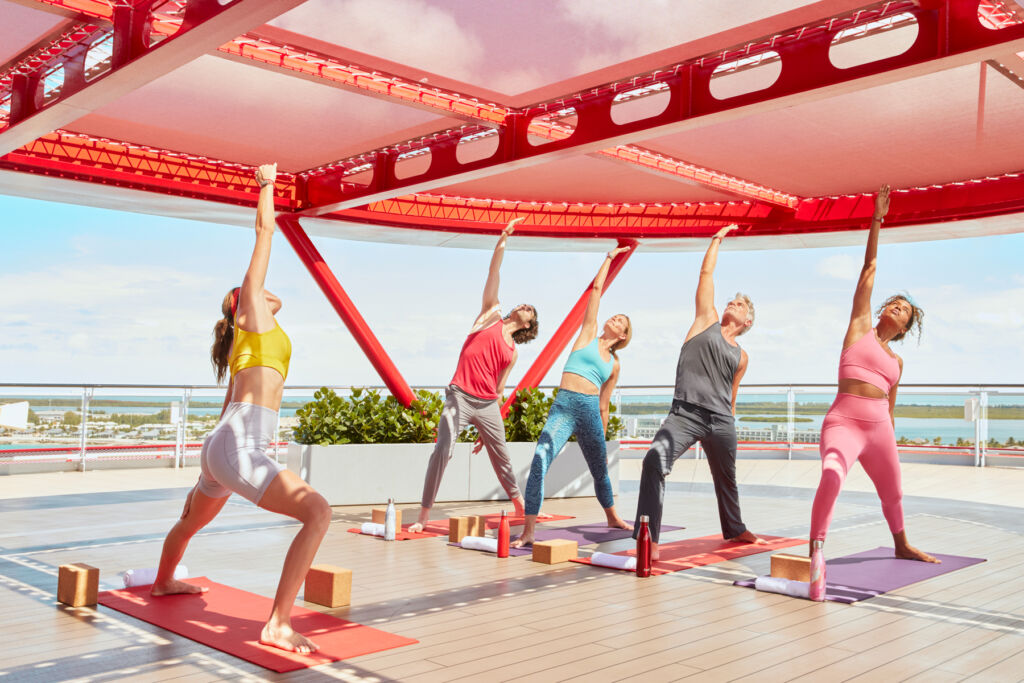 An on board yoga class with an instructor