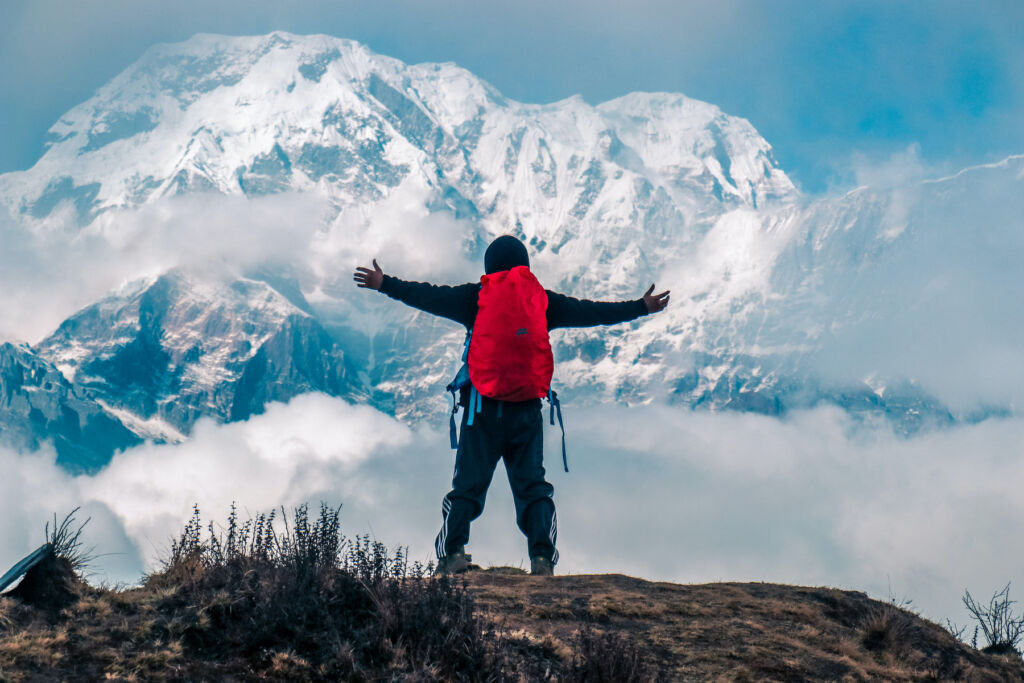 A man taking in the snow-capped mountain views on a hike