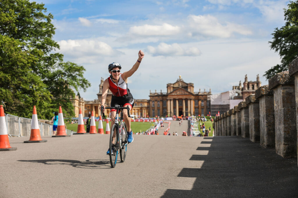 A cyclist celebrating at the Blenheim Palace Triathlon