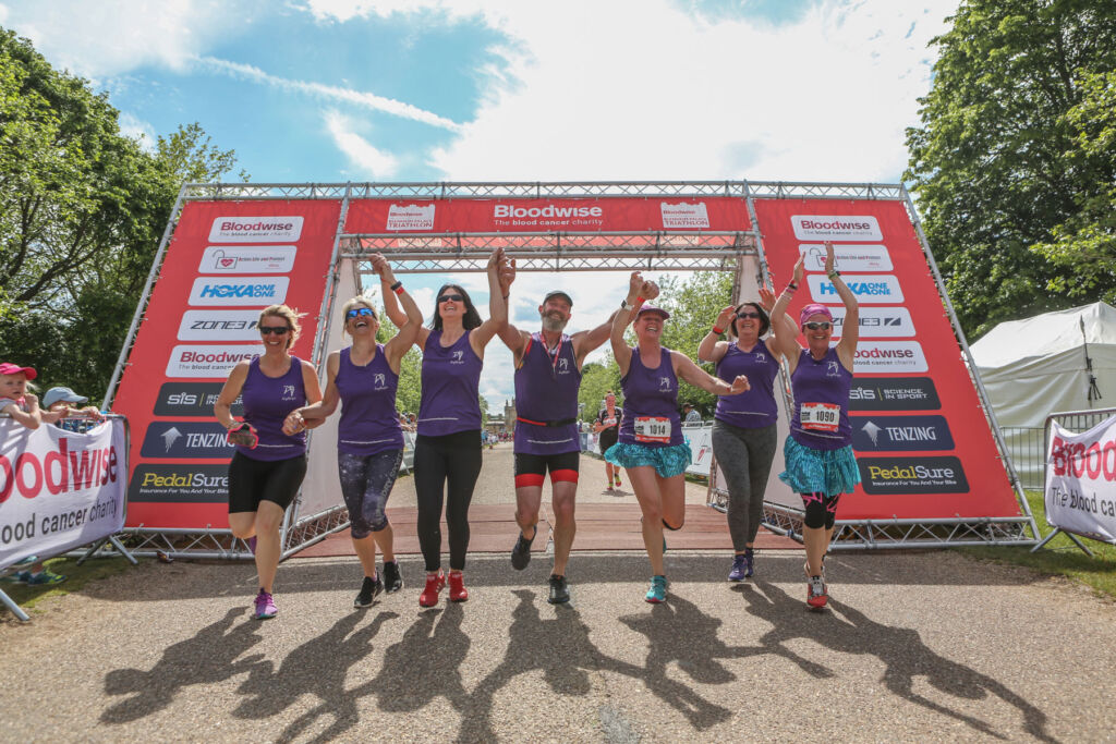 A team celebrating finishing together at the Blenheim Palace Triathlon