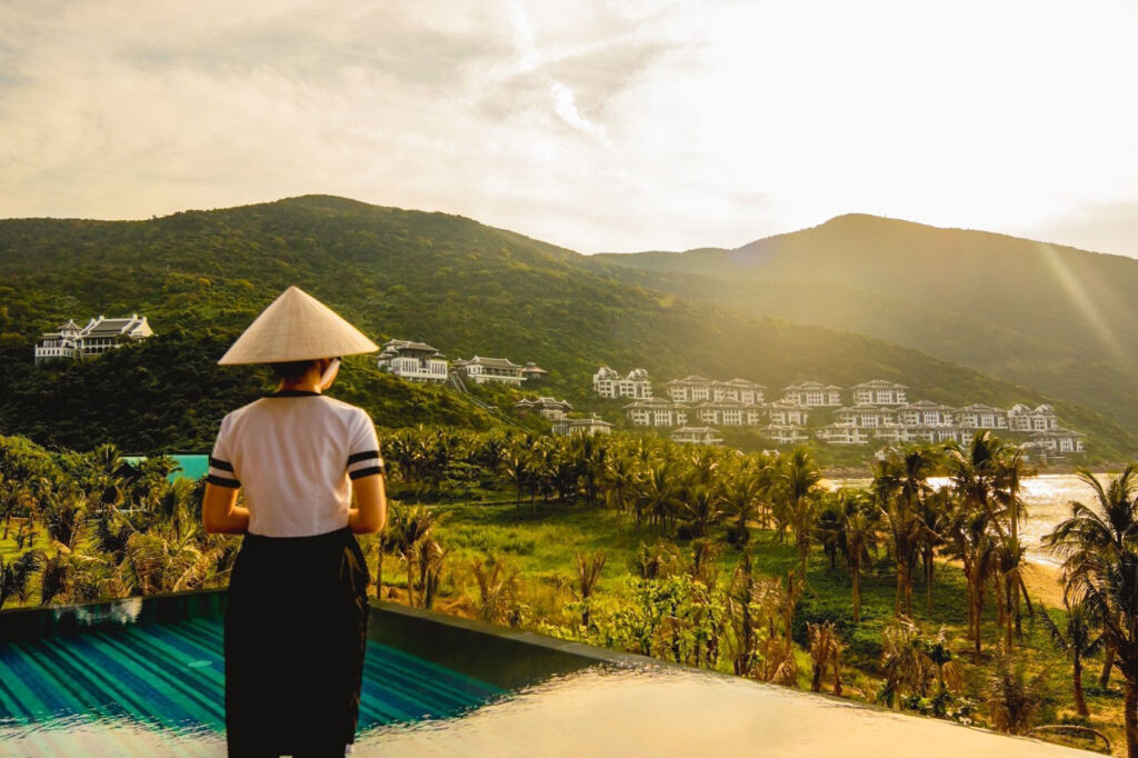 A woman on a hill looking over the InterContinental Danang Sun Peninsula Resort