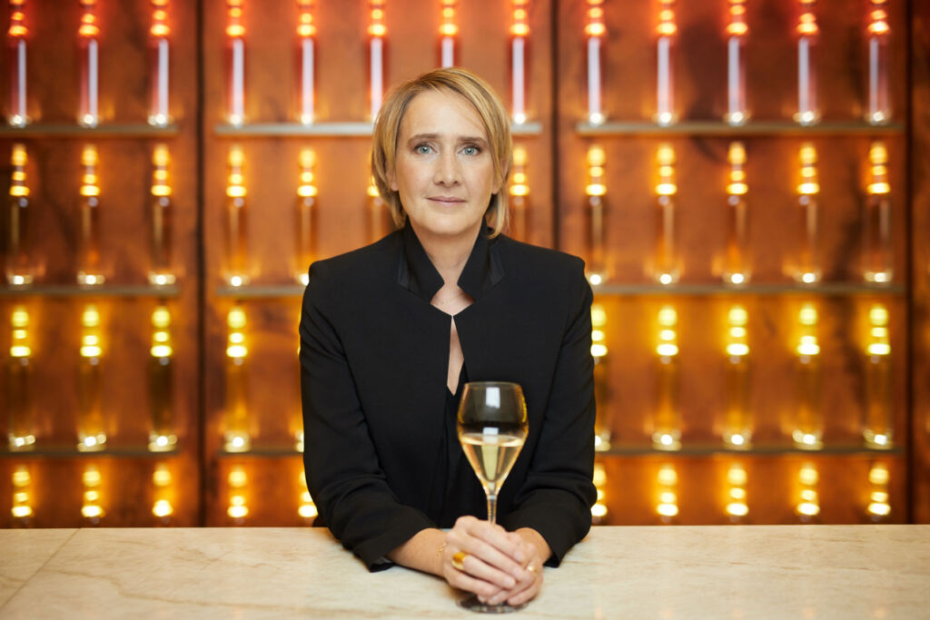 Julie Cavil holding a glass of the exceptional Champagne