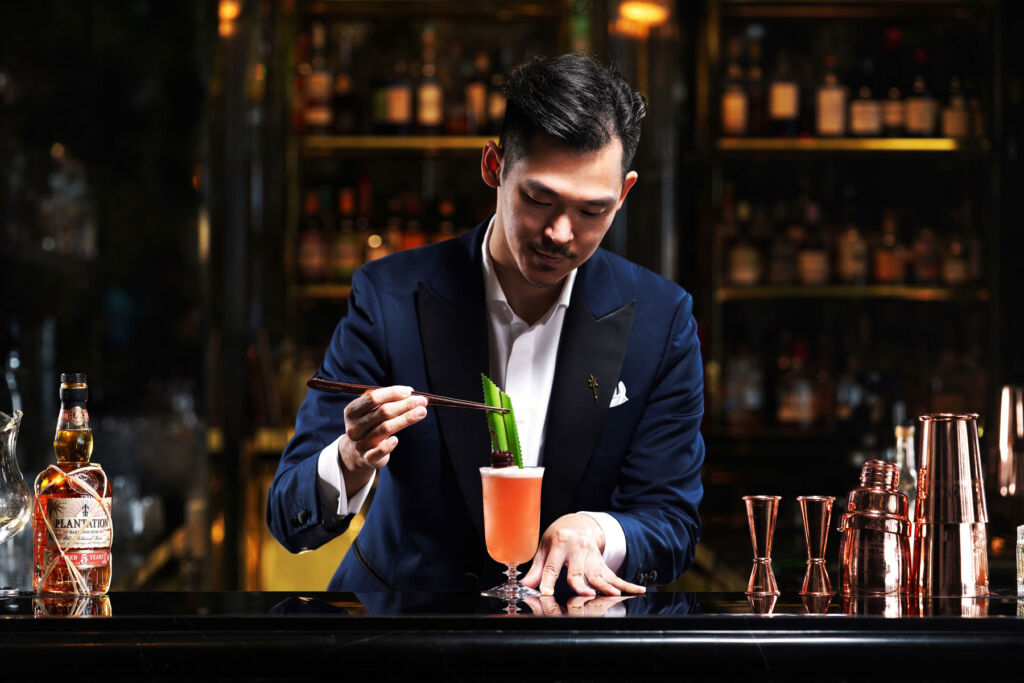 A bartender preparing the Jungle Bird cocktail at Darkside