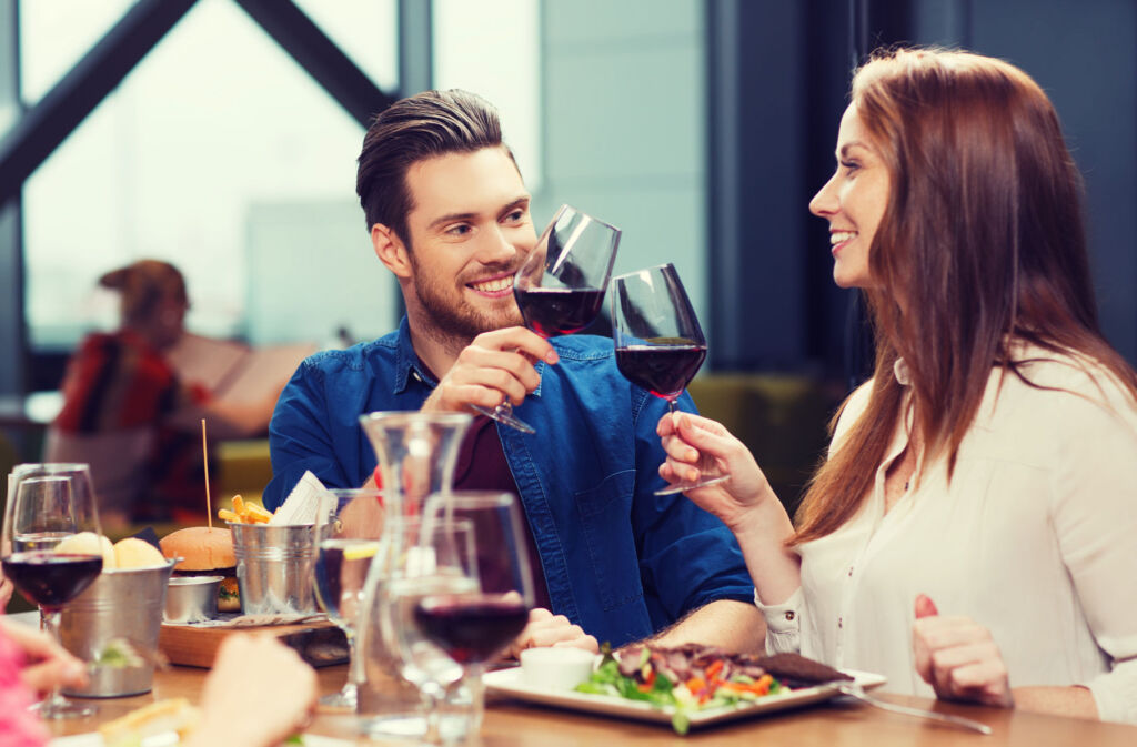 People drinking wine with food in a restaurant