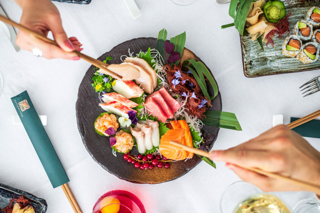Two people enjoying the Sushimi mixed platter