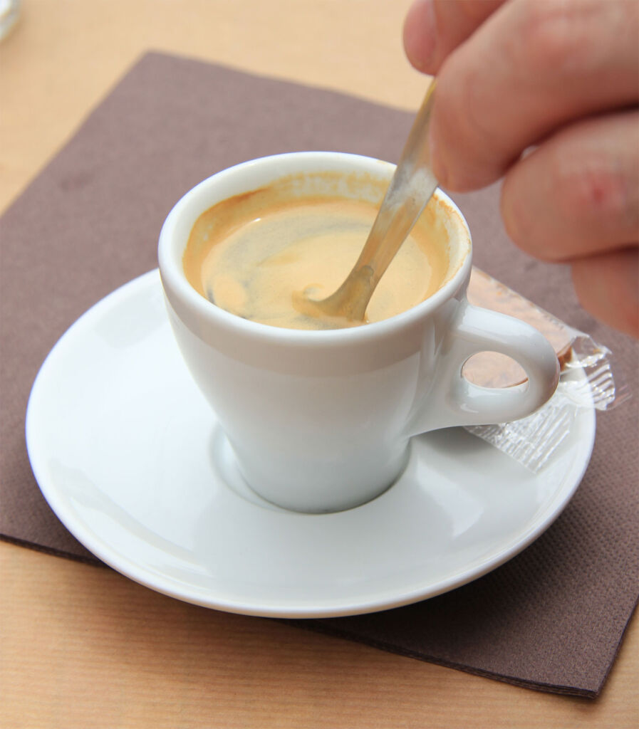 Stirring a cup of Espresso with a spoon