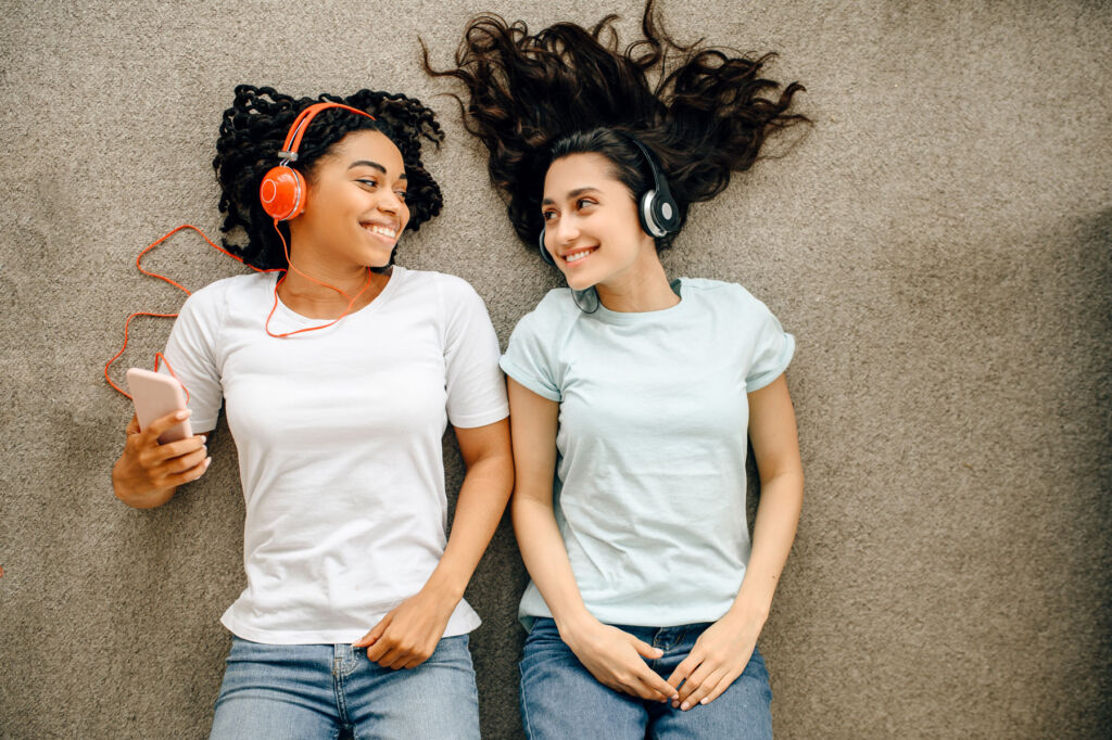 Two young girls listening to the Doffing the Hat Podcast show