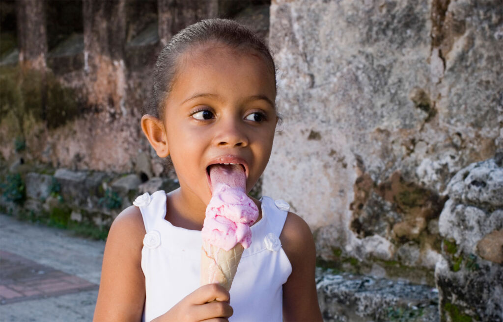 A young girl eating a home made ice cream
