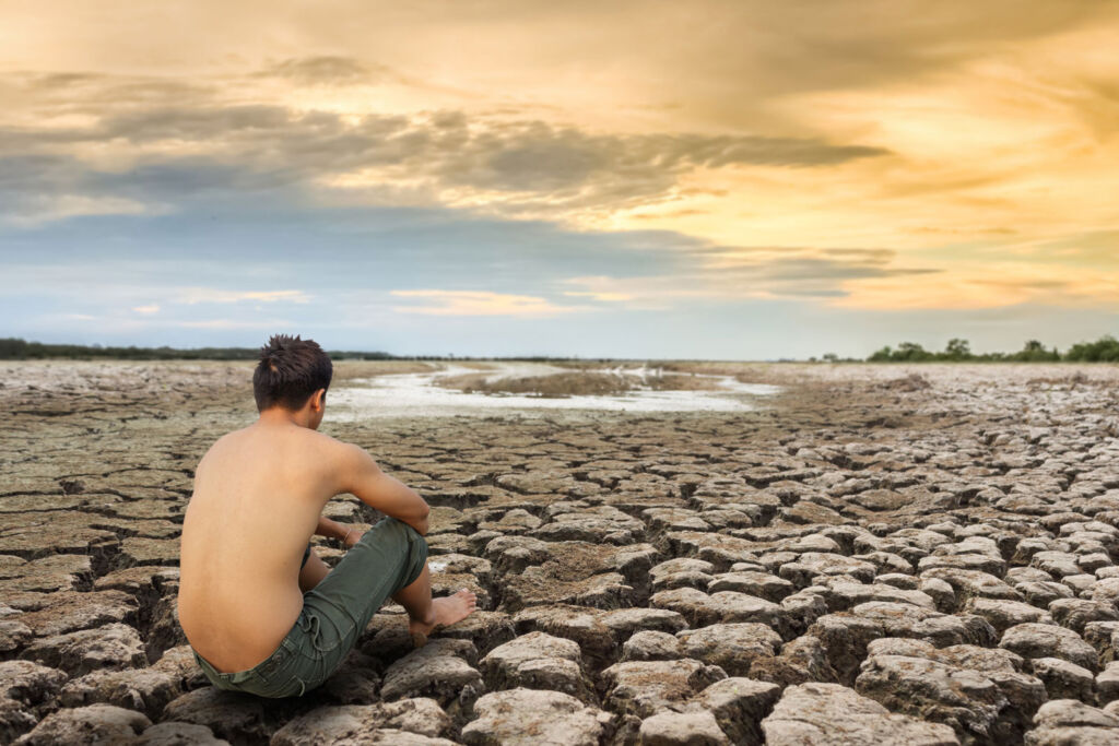 A young man sat down looking at the effects of climate change
