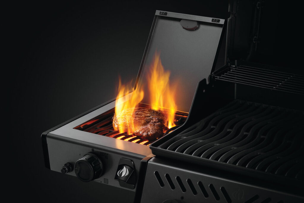 The freestyle 365 model with it's side burner grilling some meat