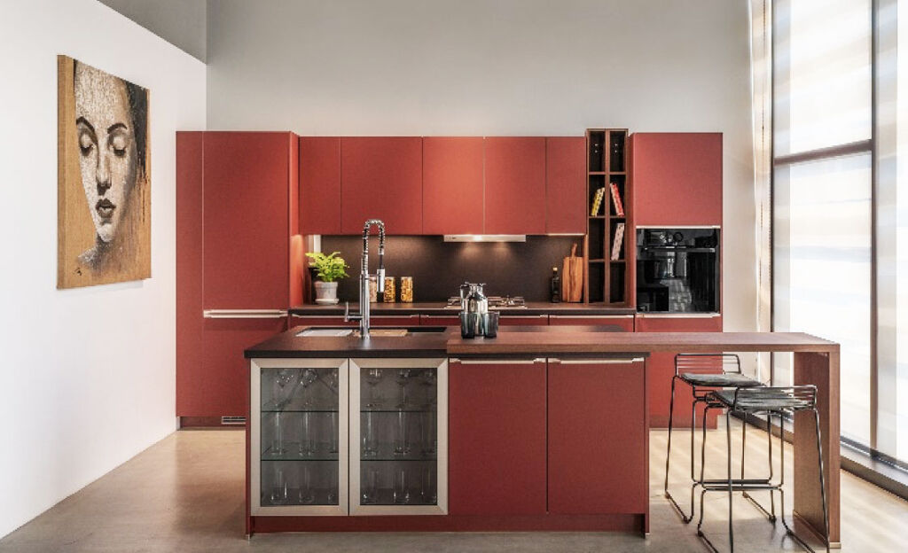A deep red coloured kitchen in the showroom