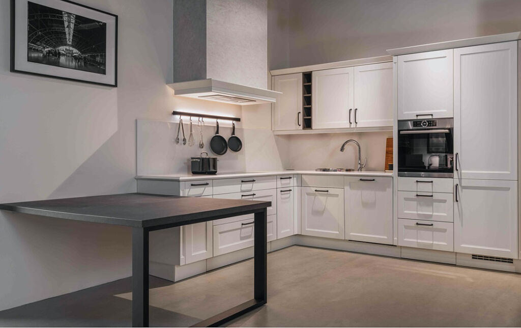 A white Shaker-style kitchen in the showroom