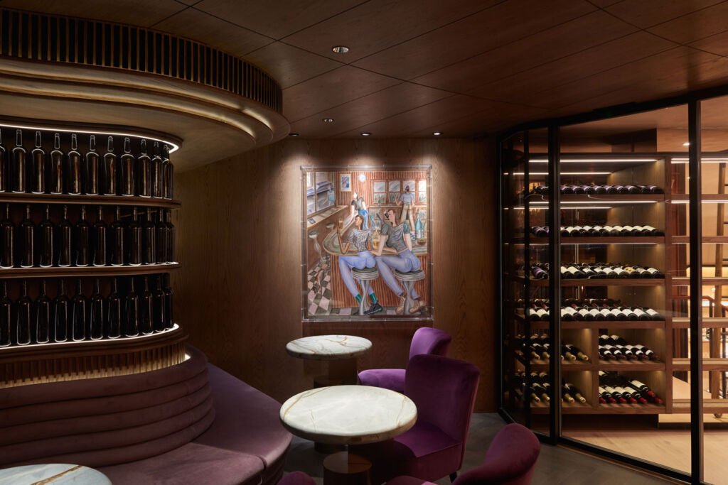 The classy interior with cabinets of rare bottles and comfortable purple coloured seating