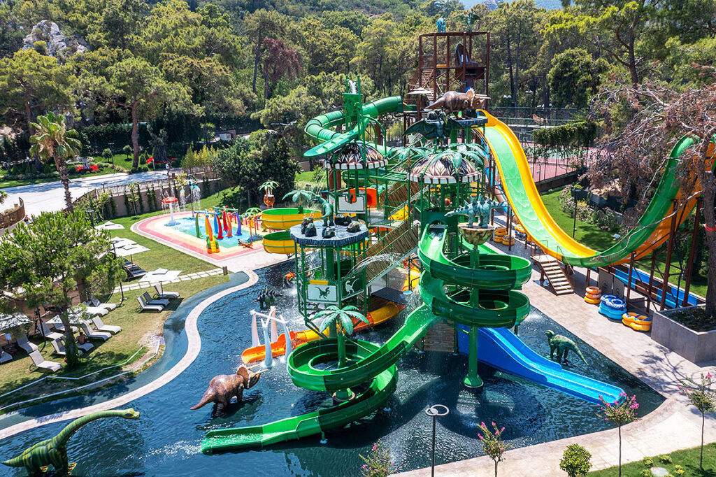 An elevated view of the kids aquapark with its dinosaur models roaming around