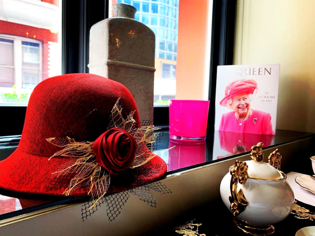 The window sill adorned with royal memorabilia including a red hat favoured by Queen Elizabeth